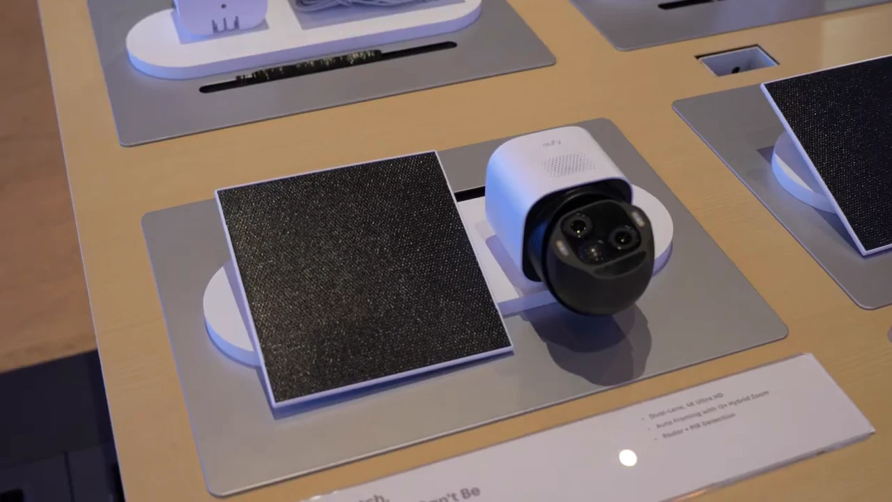 eufy SoloCam E50 and a separate solar panel viewed from above on a table.