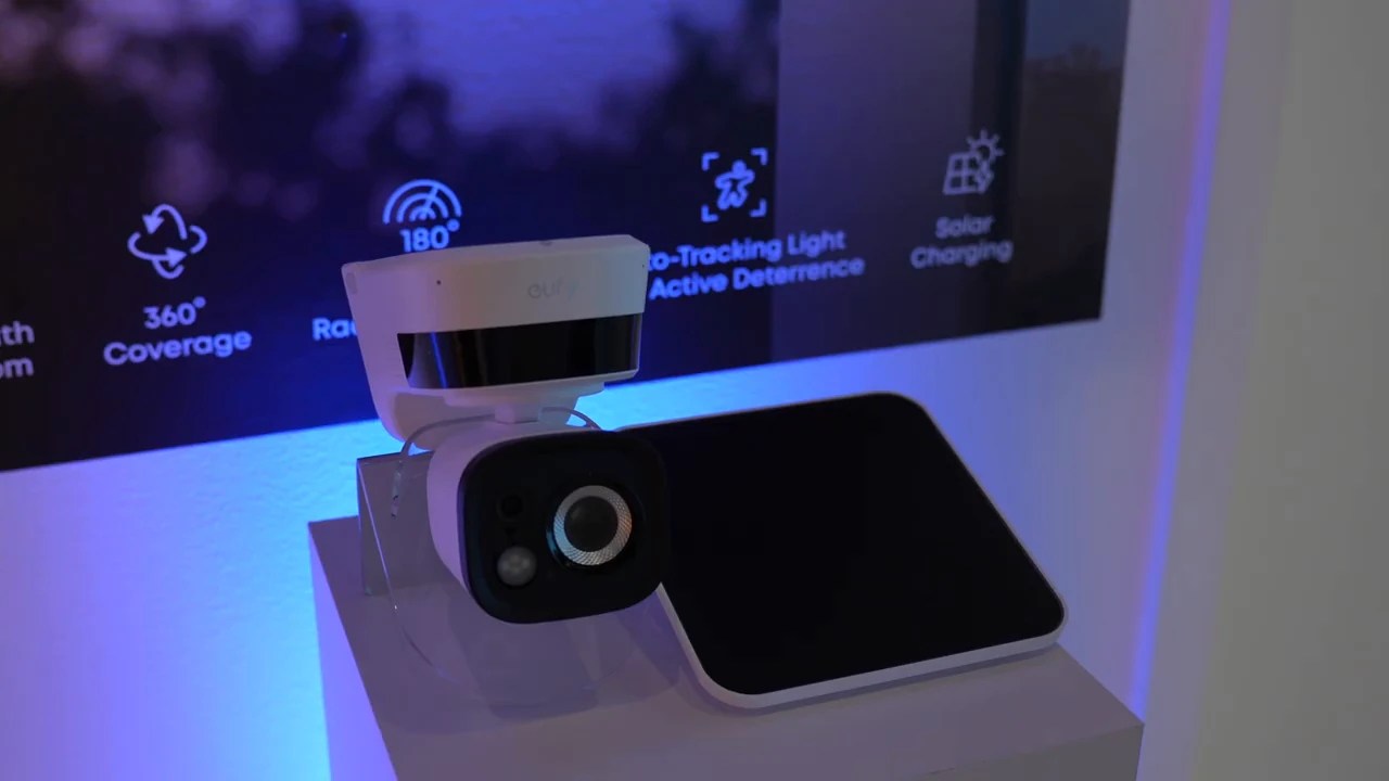 eufy TrackLight Cam S1 and its solar panel on a showcase table.
