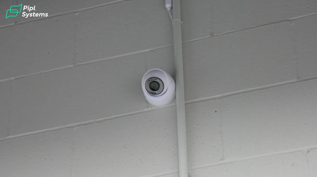 Security camera mounted on interior wall