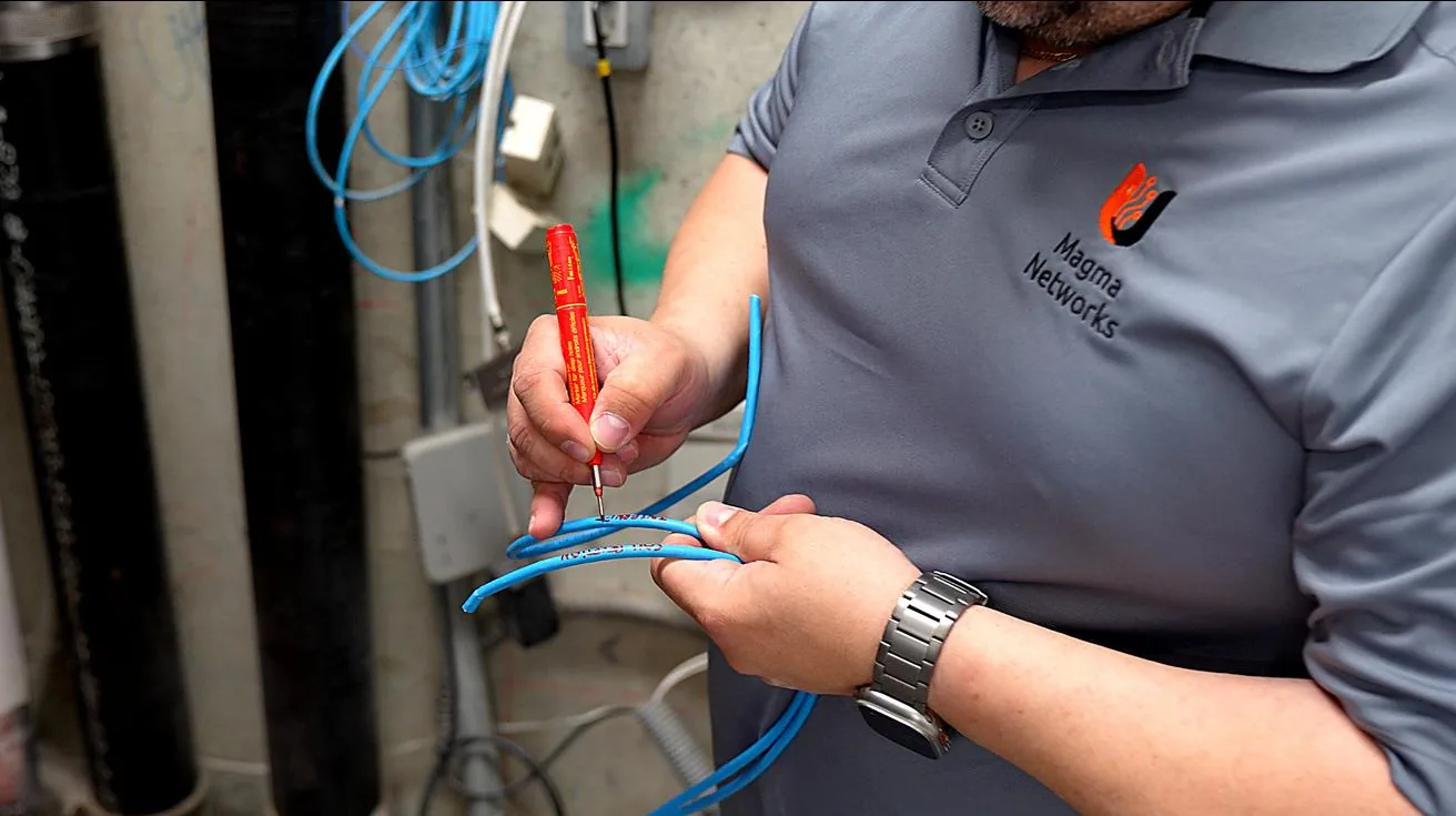 Technician labeling ethernet cable
