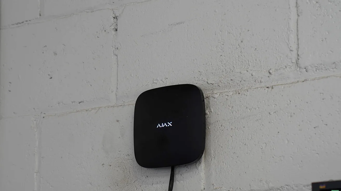 Ajax Hub 2 Plus control panel wall-mounted inside commercial facility