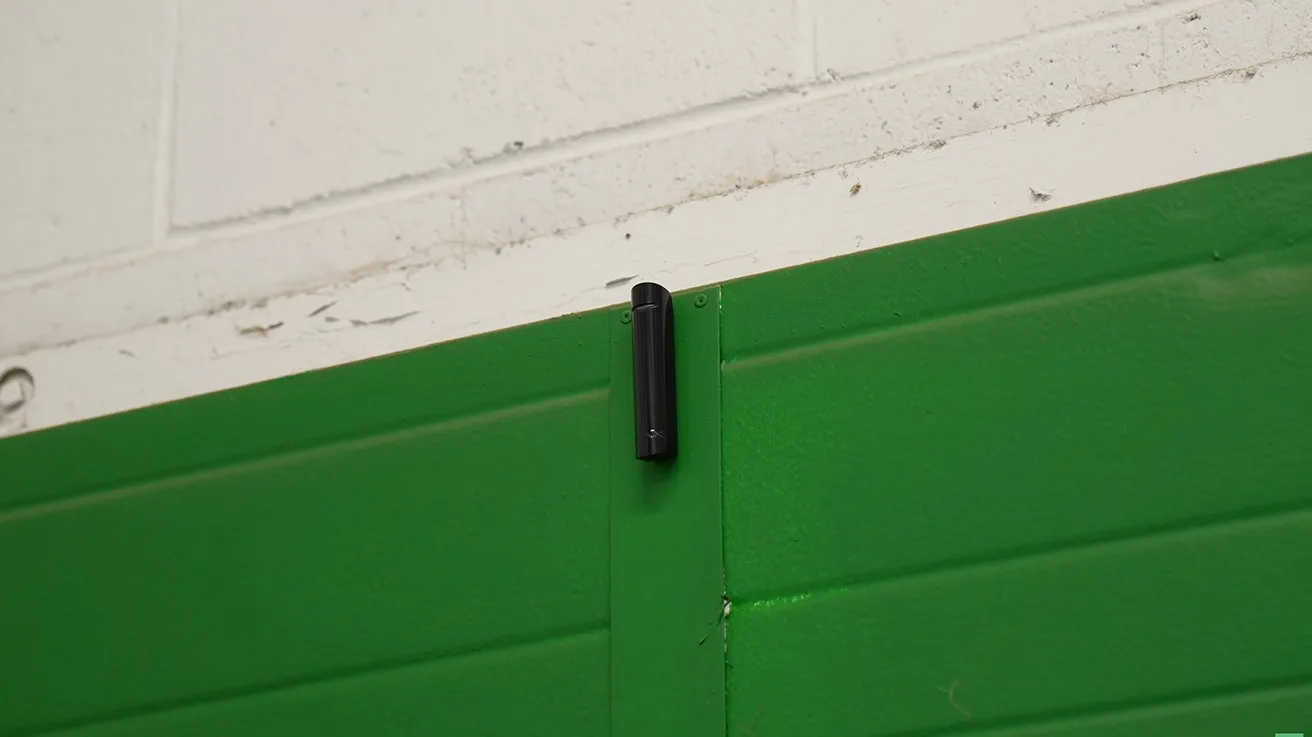 Ajax GlassProtect glass break detector installed near commercial window frame