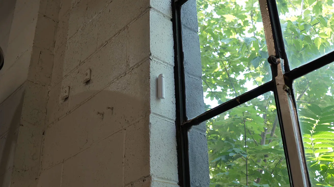 Close-up of Ajax GlassProtect microphone sensor monitoring window glass integrity