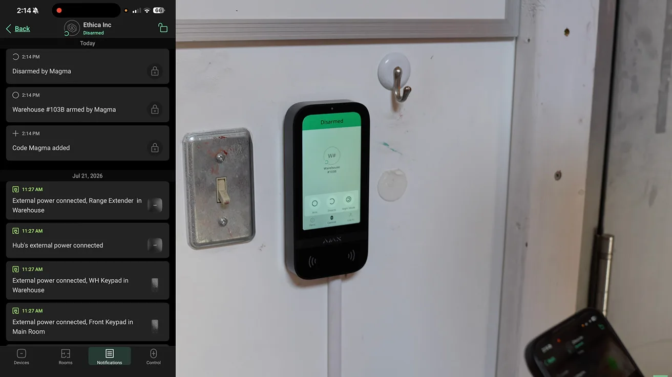 Close-up of Ajax KeyPad TouchScreen mounted on warehouse entry wall
