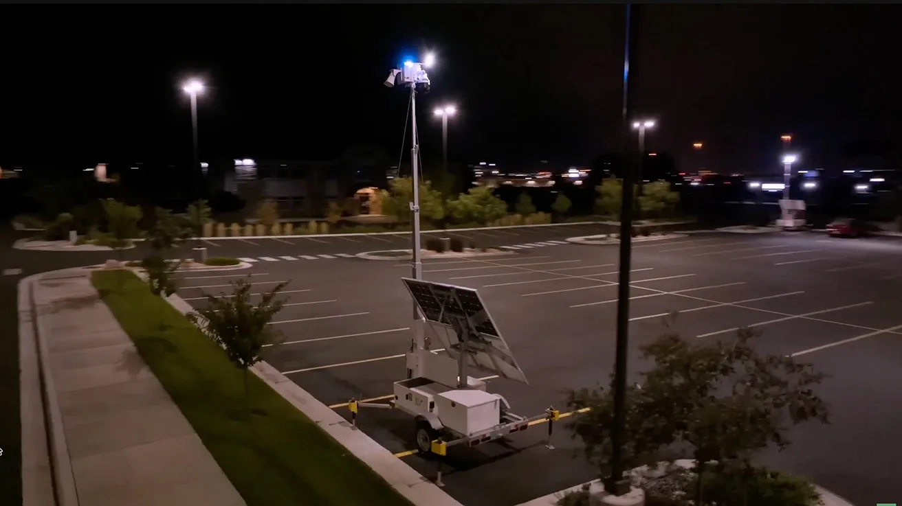 Mobile surveillance trailer operating at night with active deterrent LED floodlights and strobes