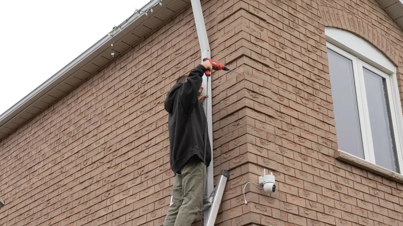 Homeowner installing the separate solar panel above the wall-mounted T2