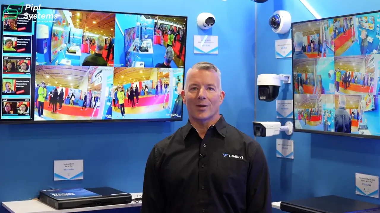 Chris Robertson at the Luminys booth with IP cameras, recorders and surveillance monitors.