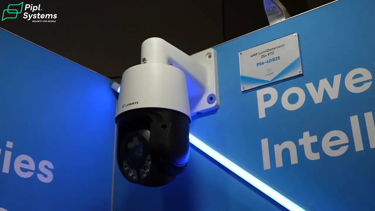 White Luminys active deterrence PTZ camera mounted on the exhibition wall.