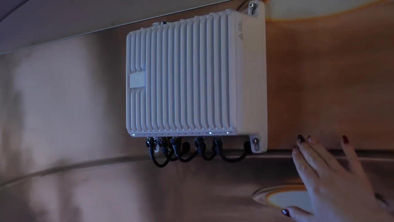 Ruggedized transportation gateway mounted on a demonstration panel with connected cables.