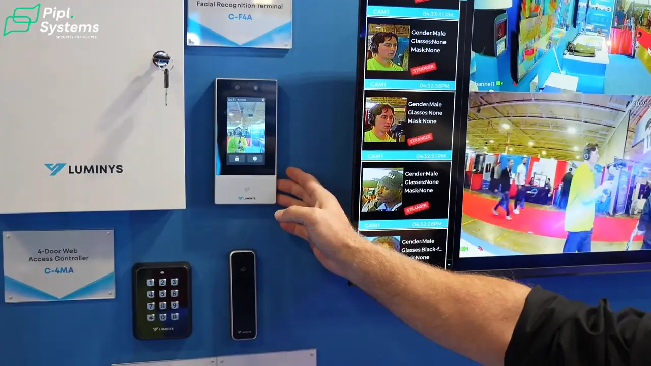 Chris Robertson indicates the touchscreen facial recognition terminal beside an access control cabinet.
